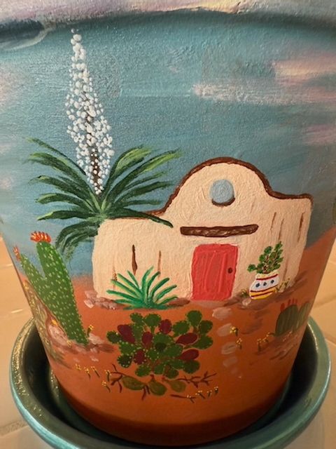 Sylvia’s hand-painted desert scene on a decorative vessel