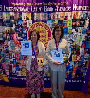 Sylvia and a fellow honoree holding their certificates at the 2025 awards