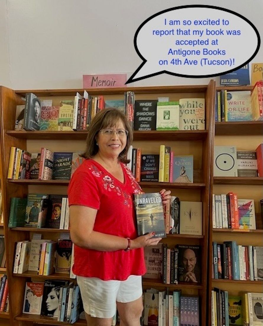 Sylvia standing in a bookstore holding Unraveled
