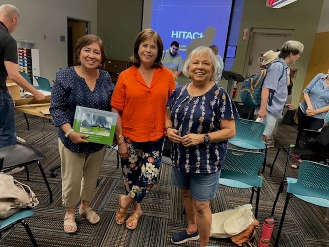 Sylvia posing with attendees